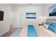 Cozy bedroom featuring neutral walls, carpet floors, a bed with blue accents, and modern artwork at 2892 Beluga Bay Dr, Odessa, FL 33556