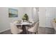 Bright dining area features a round table, four chairs, and a large colorful painting on the wall at 2892 Beluga Bay Dr, Odessa, FL 33556