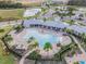 Aerial view of community pool and amenity center with lush landscaping and lounge areas at 2892 Beluga Bay Dr, Odessa, FL 33556
