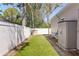 Wide-open back yard with a vinyl fence, grass and a storage shed at 3003 Magdalene Woods Dr, Tampa, FL 33618