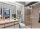 Bathroom featuring a shower, toilet, vanity with a mirror, and a window that provides natural light at 3003 Magdalene Woods Dr, Tampa, FL 33618