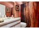 Cozy bathroom featuring a vanity, toilet, and framed mirror at 3003 Magdalene Woods Dr, Tampa, FL 33618