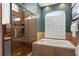 Well-lit bathroom featuring a walk-in shower, separate tub, and tiled accents at 3003 Magdalene Woods Dr, Tampa, FL 33618