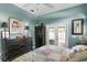 Charming bedroom featuring a colorful quilt and French doors leading to the pool area at 3003 Magdalene Woods Dr, Tampa, FL 33618
