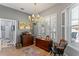 This dining area features a decorative chandelier, buffet, and a window with plantation shutters at 3003 Magdalene Woods Dr, Tampa, FL 33618