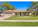 Beautiful single-story home with a well-manicured lawn and mature landscaping, enhancing its curb appeal at 3003 Magdalene Woods Dr, Tampa, FL 33618