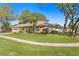 Beautiful exterior of a home with mature trees and a well-kept lawn at 3003 Magdalene Woods Dr, Tampa, FL 33618