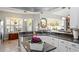 An open kitchen flows seamlessly into the living area, showcasing granite counters, white cabinets and an eat in kitchen at 3003 Magdalene Woods Dr, Tampa, FL 33618