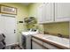 Bright laundry room with modern washer and dryer, utility sink, and plenty of storage at 3003 Magdalene Woods Dr, Tampa, FL 33618