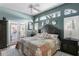 Inviting main bedroom featuring a patchwork quilt, ceiling fan, and pool views at 3003 Magdalene Woods Dr, Tampa, FL 33618