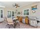 Outdoor kitchen area with granite countertop, mini refrigerator, and a stainless-steel grill at 3003 Magdalene Woods Dr, Tampa, FL 33618