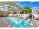 Sparkling screened-in pool with brick paver deck, perfect for outdoor relaxation and entertainment at 3003 Magdalene Woods Dr, Tampa, FL 33618