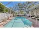 Inviting screened-in pool area with ample space for lounging and enjoying the outdoors at 3003 Magdalene Woods Dr, Tampa, FL 33618