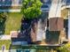 Birds eye view of the home's layout, featuring the backyard, street view and neighboring houses with a white picket fence at 3194 Brookview Ave, Largo, FL 33771