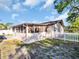 Well-maintained home features a screened porch and a charming white picket fence at 3194 Brookview Ave, Largo, FL 33771