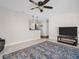 Cozy living room features a ceiling fan, a blue rug and entertainment area at 3194 Brookview Ave, Largo, FL 33771