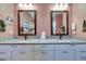 Dual vanity bathroom featuring granite countertops, framed mirrors, and modern fixtures at 329 Laurel Falls Dr, Apollo Beach, FL 33572