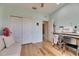 Bedroom showcasing wood floors, light blue walls, closet space, and access to a hallway at 329 Laurel Falls Dr, Apollo Beach, FL 33572