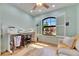 Sunlit bedroom with wood floors, plantation shutters, a ceiling fan, and ample space at 329 Laurel Falls Dr, Apollo Beach, FL 33572