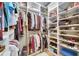 Organized walk-in closet with shelving, hanging racks, and ample storage space for clothes and shoes at 329 Laurel Falls Dr, Apollo Beach, FL 33572