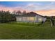 Expansive backyard with black fencing surrounding the property with verdant lawn at 34411 Sahalee Loop, Dade City, FL 33525
