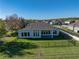 This backyard offers ample green space, surrounded by a secure black fence and lush landscaping at 34411 Sahalee Loop, Dade City, FL 33525