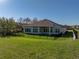 Home exterior showcasing fenced yard with ample space and manicured landscaping at 34411 Sahalee Loop, Dade City, FL 33525