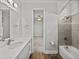 Bright bathroom with quartz vanity, decorative mirror, tiled shower, and a bathtub at 34411 Sahalee Loop, Dade City, FL 33525
