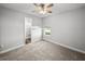 Clean bedroom with carpet, a ceiling fan, and an en-suite bathroom at 34411 Sahalee Loop, Dade City, FL 33525