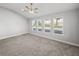 Bright bedroom with vaulted ceiling, neutral paint, plush carpeting, and three big windows at 34411 Sahalee Loop, Dade City, FL 33525