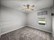 This bedroom has neutral walls, carpet, and a ceiling fan, offering a blank canvas for personalization at 34411 Sahalee Loop, Dade City, FL 33525