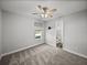 Bright bedroom features a large window, ceiling fan, and an ensuite bathroom at 34411 Sahalee Loop, Dade City, FL 33525