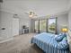 The bedroom features carpeted floors, windows with backyard views, and a ceiling fan at 34411 Sahalee Loop, Dade City, FL 33525