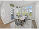 The dining area features a wooden table, six chairs, and backyard views at 34411 Sahalee Loop, Dade City, FL 33525
