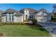 Charming single-Gathering home boasting manicured lawns, a brick driveway, and inviting curb appeal at 34411 Sahalee Loop, Dade City, FL 33525