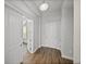 Bright foyer featuring wood floors, white doors and trim, and a modern light fixture at 34411 Sahalee Loop, Dade City, FL 33525