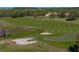 Scenic view of well-manicured golf course with sand traps, trees, and water hazard at 34411 Sahalee Loop, Dade City, FL 33525