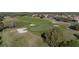 This picturesque golf course features a green, sand traps, and lush surroundings at 34411 Sahalee Loop, Dade City, FL 33525