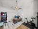 A home office with wood floors, ceiling fan, and large desk area; an exercise bike is also shown at 34411 Sahalee Loop, Dade City, FL 33525