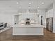 Modern kitchen with quartz countertops, stainless steel appliances, and pendant lighting at 34411 Sahalee Loop, Dade City, FL 33525