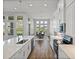 A modern kitchen with stainless appliances, white cabinets and a view to the dining area at 34411 Sahalee Loop, Dade City, FL 33525