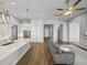 Open living room connects to a modern kitchen with granite countertops and stainless steel appliances at 34411 Sahalee Loop, Dade City, FL 33525