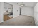 Open-concept view from carpeted living room into the hardwood floor living room and kitchen at 34411 Sahalee Loop, Dade City, FL 33525