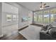 Comfortable living room featuring wood floors, large windows, and access to another room at 34411 Sahalee Loop, Dade City, FL 33525