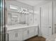 Bathroom vanity and mirror, with a soaking tub and walk-in shower nearby at 34411 Sahalee Loop, Dade City, FL 33525