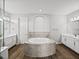 Bright bathroom with dual sink vanities, tiled tub, and modern finishes at 34411 Sahalee Loop, Dade City, FL 33525