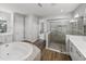 Bathroom with a soaking tub, glass enclosed shower, and dual sink vanity at 34411 Sahalee Loop, Dade City, FL 33525