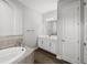 A bright bathroom with a soaking tub and granite vanity at 34411 Sahalee Loop, Dade City, FL 33525