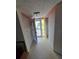 Hallway with a view to the exterior and side room, currently ready for customization at 3902 Trophy Blvd, New Port Richey, FL 34655