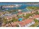 Stunning aerial view of a townhome community with a pool, tennis courts, and beautiful waterfront access at 442 Sandy Hook Rd, Treasure Island, FL 33706